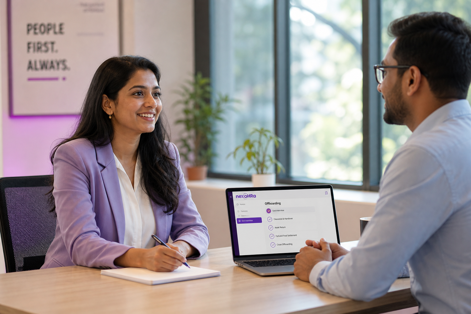 Respectful exit interview between HR and a departing employee with the nexoHRa offboarding checklist on a laptop